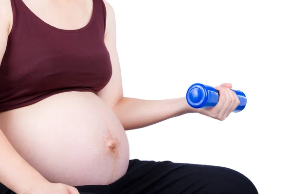 Pregnant woman exercising with dumbbell — Stock Photo, Image