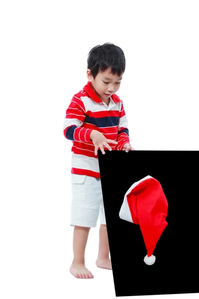 Wh で分離された黒板とサンタ帽子を探している小さな男の子 — ストック写真