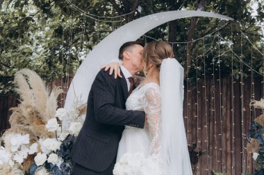 Şık bir çiftin yaz aylarında güzel bir uzay nikahı, takım elbiseli bir damat ve beyaz bir gelinlik içinde gelin..