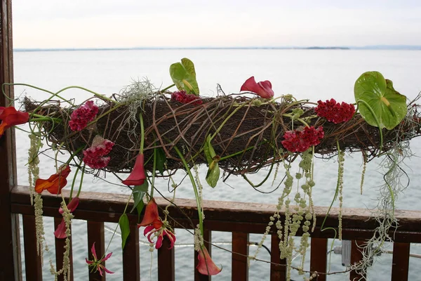 Flower arrangement of exotic tropical flowers overlooking water