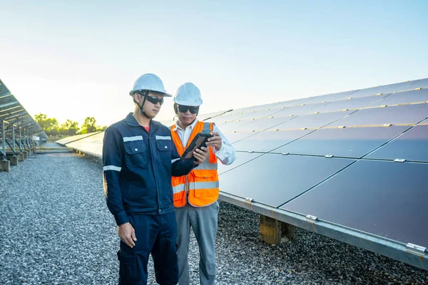 Engineers with investor walk to check the operation of the solar farm(solar panel) systems, Alternative energy to conserve the world is energy, Photovoltaic module idea for clean energy production.