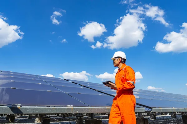 The solar farm(solar panel) with engineers walk to check the operation of the system, Alternative energy to conserve the world\'s energy, Photovoltaic module idea for clean energy production.