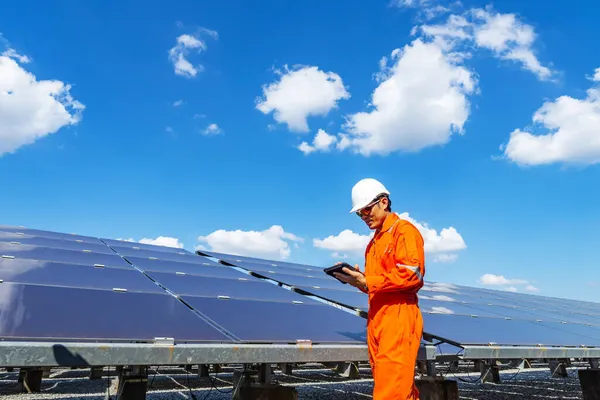 The solar farm(solar panel) with engineers walk to check the operation of the system, Alternative energy to conserve the world\'s energy, Photovoltaic module idea for clean energy production.