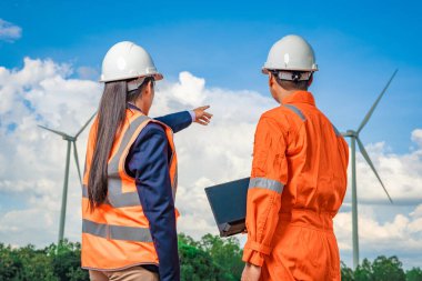 Engineers take investors on a tour of wind power plants. Wind turbines are an alternative electricity source to be sustainable resources in the future. Clean energy concept saves the world.