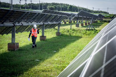 The technician takes the Thermoscan(thermal image camera) scan to the solar panel to check the hot spots in the cell, Concept to use technology to check the damage in the Solar plant.