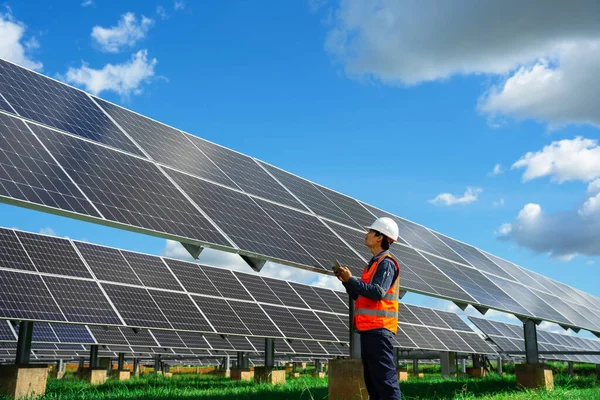 Technicians are checking the operation of the solar power plant equipment so that the power generation can operate at full capacity. Alternative energy to conserve the world\'s energy.