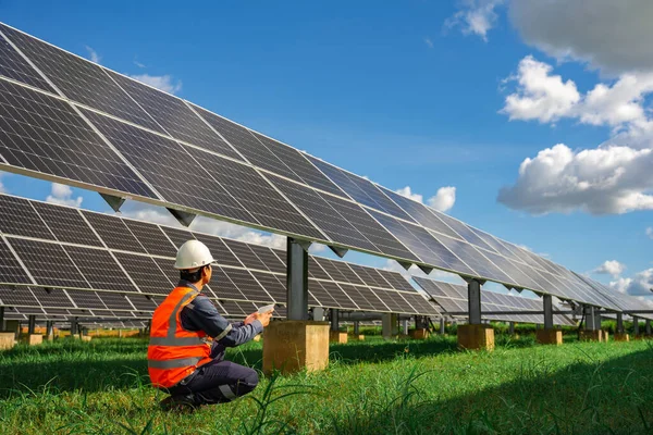 Technicians are checking the operation of the solar power plant equipment so that the power generation can operate at full capacity. Alternative energy to conserve the world\'s energy.