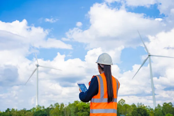 Investors on a tour of wind power plants. Wind turbines are an alternative electricity source to be sustainable resources in the future. Clean energy concept saves the world.