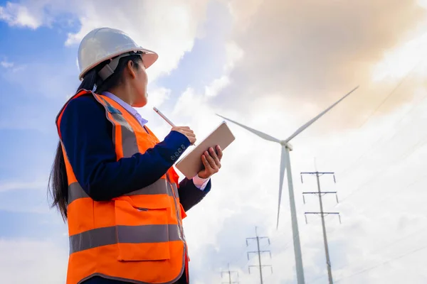 Investors on a tour of wind power plants. Wind turbines are an alternative electricity source to be sustainable resources in the future. Clean energy concept saves the world.