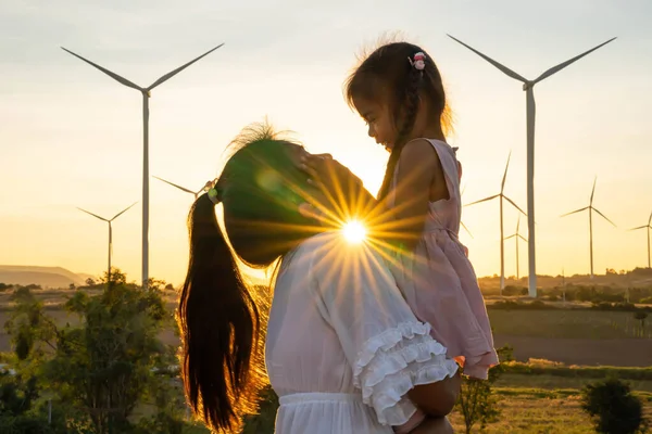 Wind turbines are alternative electricity sources, the concept of sustainable resources, People in the community with wind generators turbines, Renewable energy.