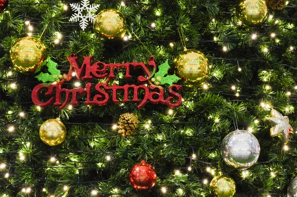 Merry Christmas sign on the tree — Stock Photo, Image