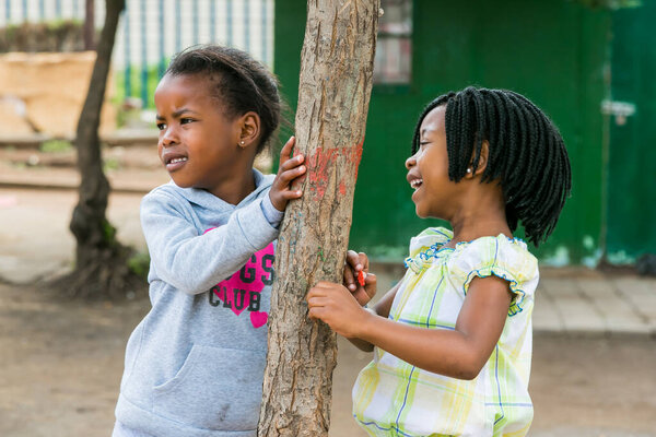 Johannesburg, South Africa - December 15, 2016: African children playing in school yard playground