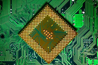 Macro Close up of microchips and pins on Main CPU PC processor circuit board.	