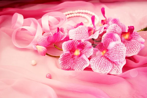 Pink orchids, necklace and beads — Stock Photo, Image