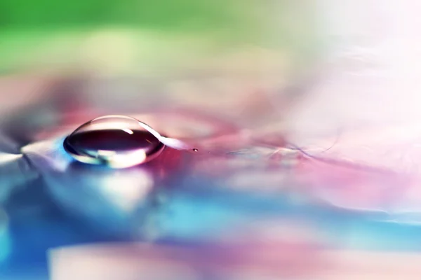 Macro shot of bubble on a soft blue and pink background — Stock Photo, Image