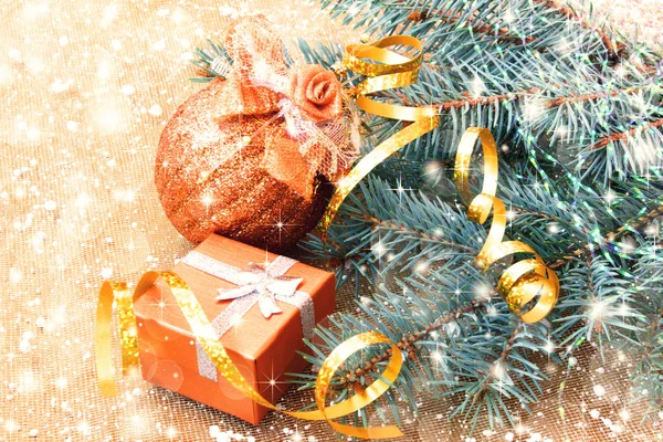 Golden ball, gift box and christmas tree branches — Stock Photo, Image