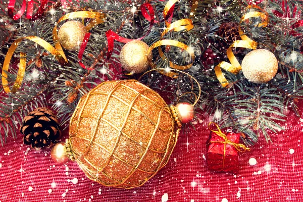 Shiny golden ball and decorated christmas tree twigs — Stock Photo, Image