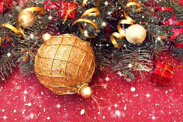 Golden ball and decorated christmas tree twigs — Stock Photo, Image