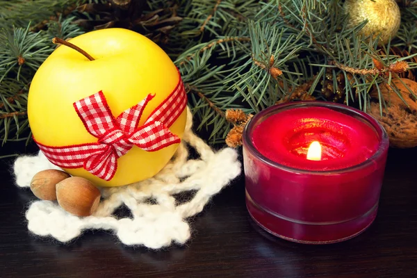 Christmas apple and festive red candle — Stock Photo, Image