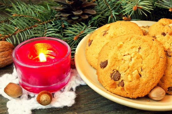 Christmas cookies and red candle close up — Stock Photo, Image