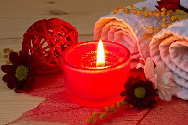 Red aroma candle close up and spa stuff Stock Photo