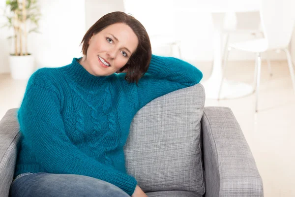 Pretty woman wearing blue shirt at home. — Stock Photo, Image