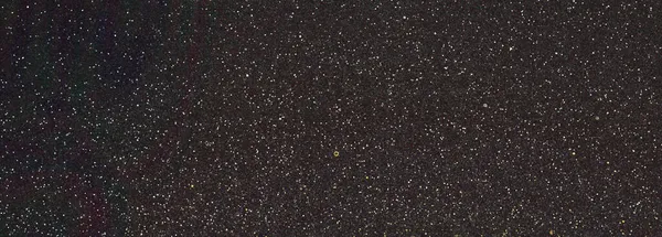 Soyut, yatay koyu renkli arkaplan ve ışık sıçramaları. 