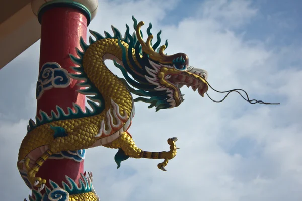 Dragão chinês dourado Envolvido em torno de pólo vermelho e céu brilhante — Fotografia de Stock