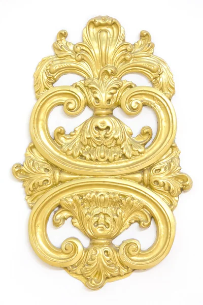 De um antigo ornamento dourado sobre um fundo branco — Fotografia de Stock