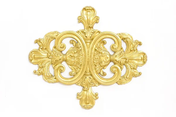 De un antiguo ornamento de oro sobre un fondo blanco — Foto de Stock