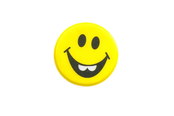 Bright, adesivo amarelo com um rosto sorridente — Fotografia de Stock