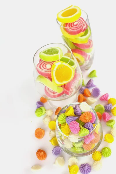 Colorful candy in glass saucer and bowl isolated on white backgr — Stock Photo, Image