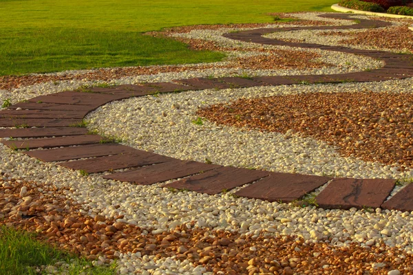 Stone walkway in the park with green grass — Stock Photo, Image