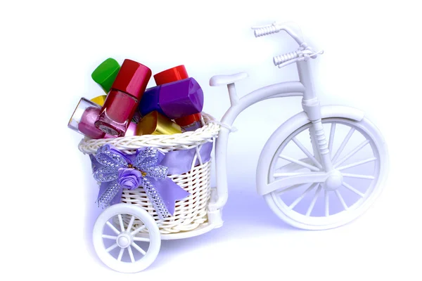 Multi color nail polish set on Vase rides a tricycle — Stock Photo, Image