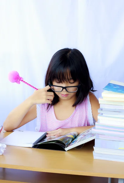 Porträt eines fröhlichen asiatischen jungen Mädchens, das seine Hausaufgaben macht — Stockfoto