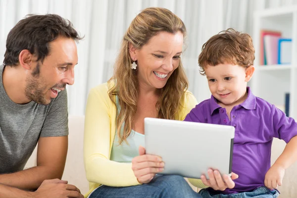 Mother showing something on the tablet to her son — Stock Photo, Image