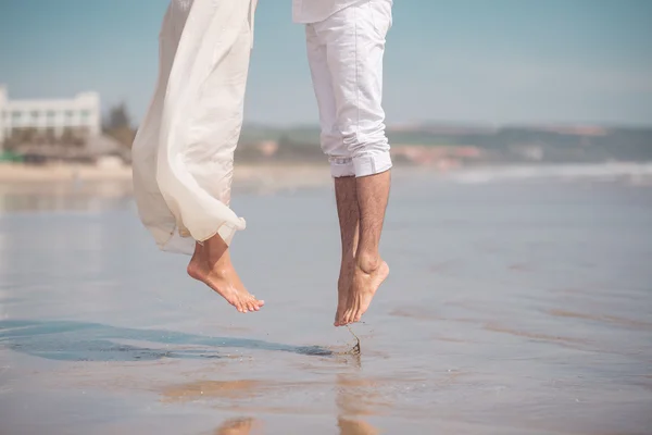 Paar springt am Strand — Stockfoto