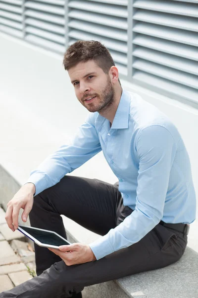 Handsome businessman with a tablet — Stock Photo, Image