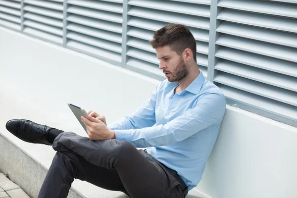 Handsome businessman with a tablet — Stock Photo, Image