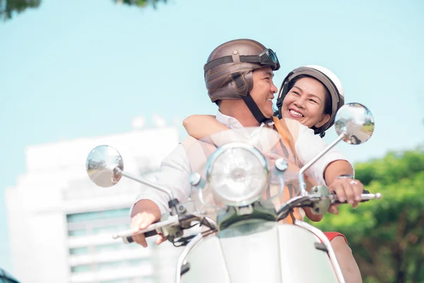 Happy seniors on the scooter — Stock Photo, Image