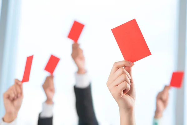 Manos mostrando tarjetas rojas — Foto de Stock