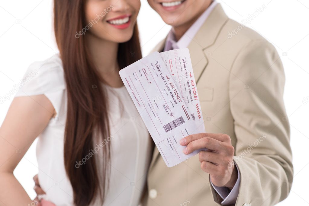 Happy couple with boarding passes