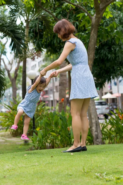Mother spinning her daughter — Stock Photo, Image