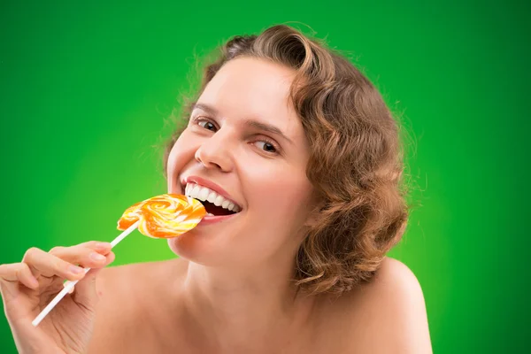 Pretty lady baiting lollipop — Stock Photo, Image