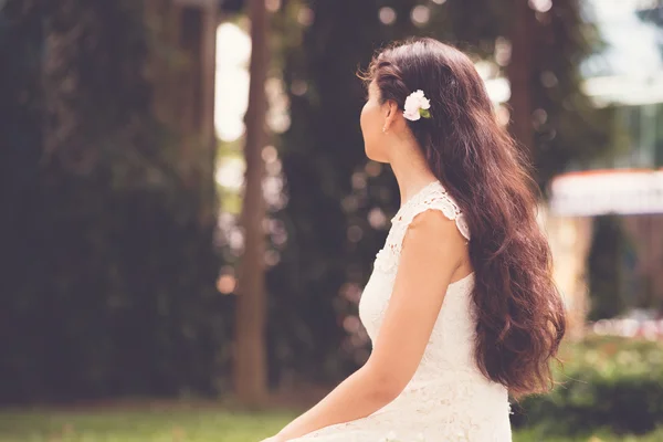 Carnation flower in hair — Stock Photo, Image