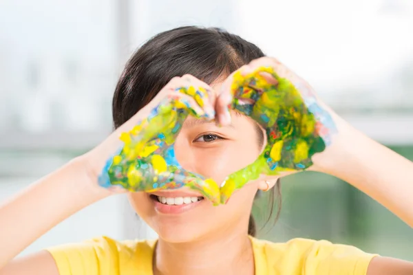 Schoolgirl with painted palms — Stock Photo, Image