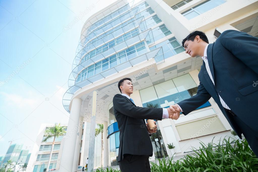 Asian businessmen shaking their hands