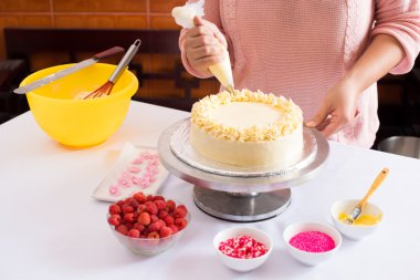 Woman decorating cake