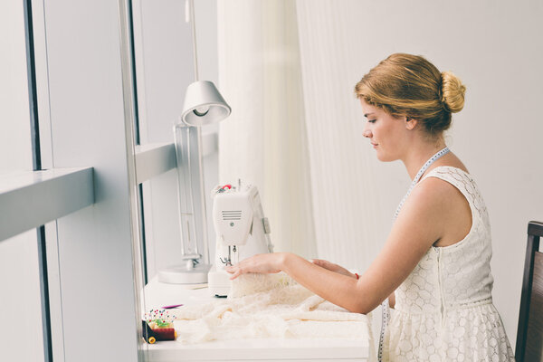 Tailor sewing on sewing machine
