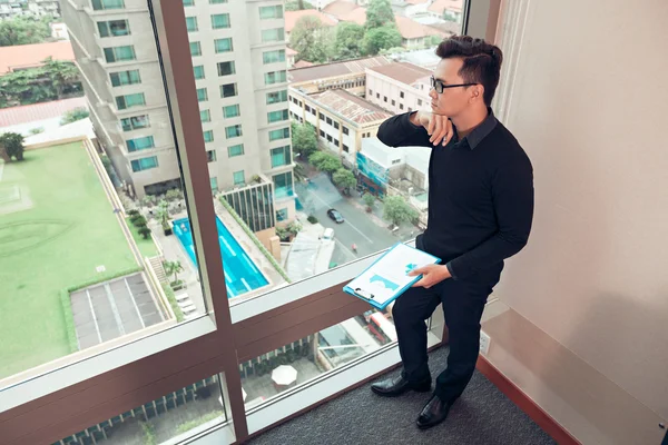 Επιχειρηματίας που στέκεται δίπλα στο παράθυρο — Φωτογραφία Αρχείου
